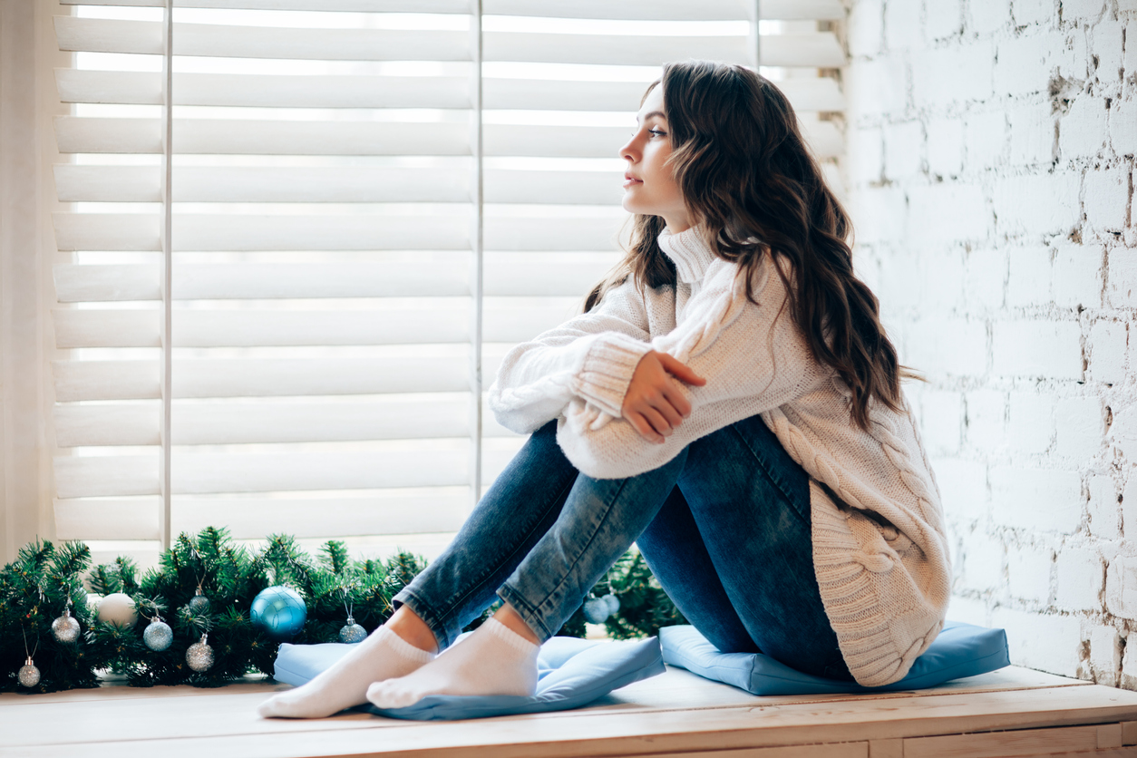 stock photo of young woman looking outside