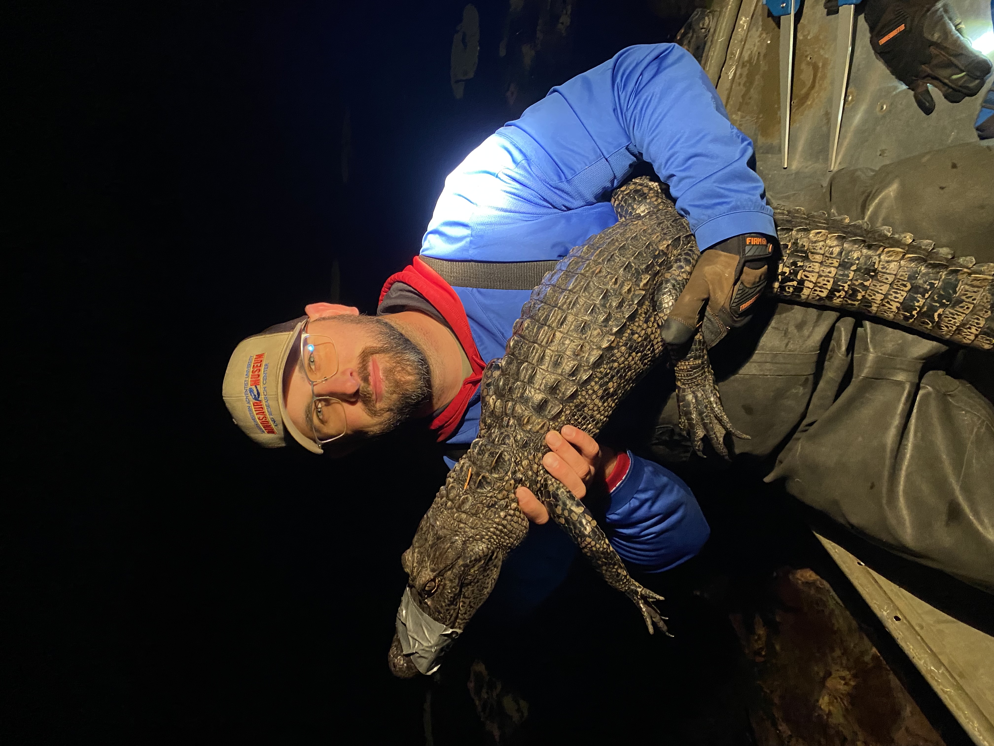 Jared Woods with gator at night
