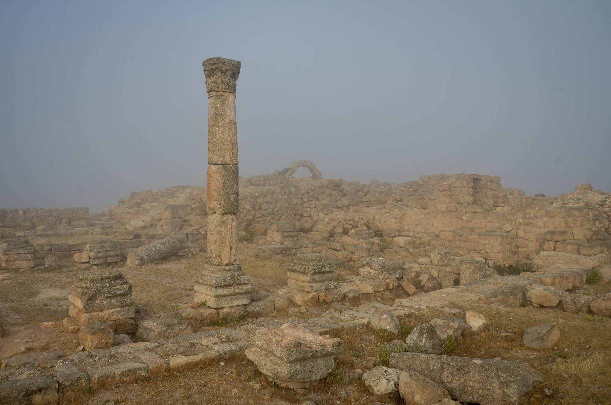Remains of a Byzantine church, and in the far background, an arch from the Mamluk Dynasty shrouded in haze at Tall Hisban. (Courtesy: Doug Clark)
