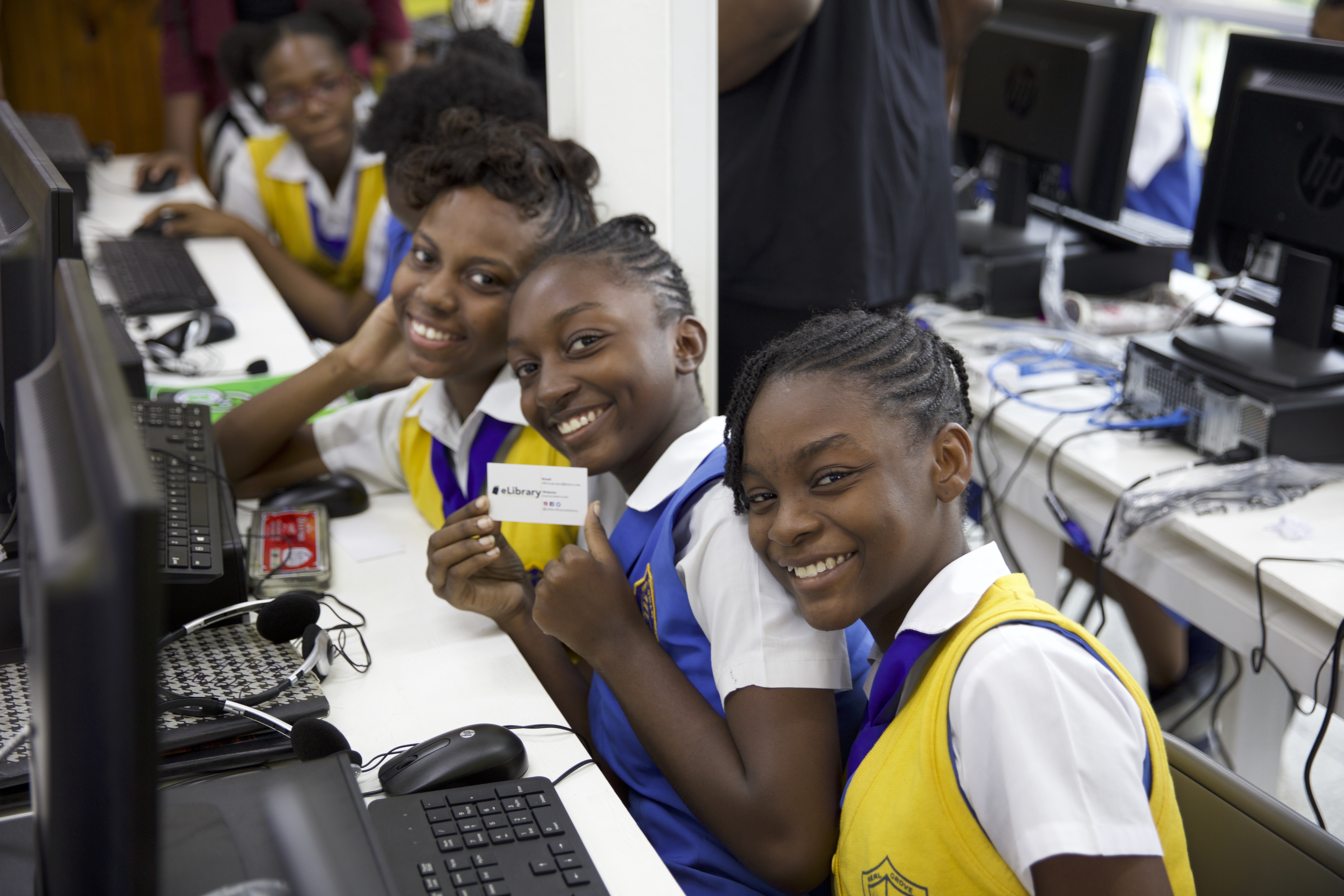 Students in Jamaica pose for a photo while receiving instruction from members of the La Sierra University Enactus team on how to use the revolutionary flash drive-based eLibrary system. (Photos courtesy of La Sierra University Enactus)
