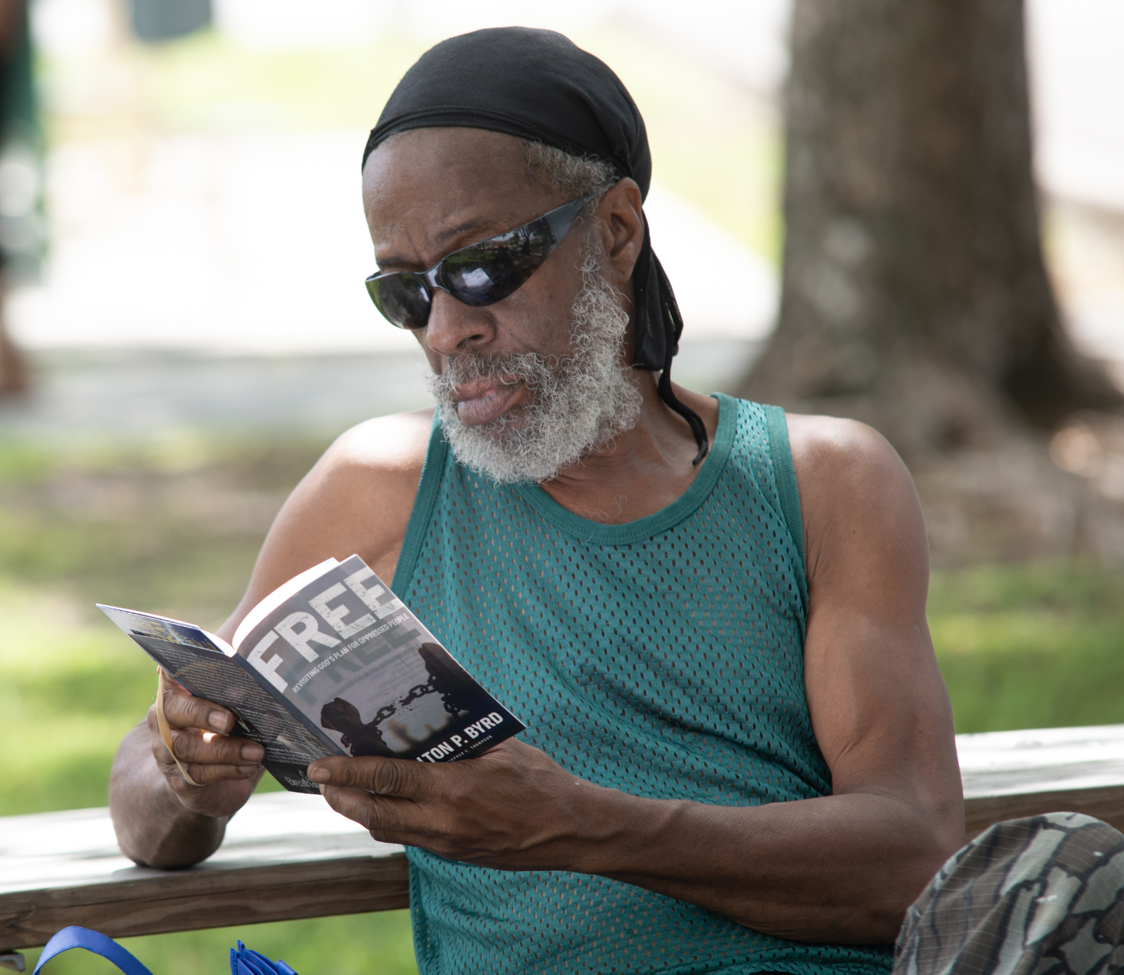 Community member in Miami-area reads a copy of FREE: Revisiting God’s Plan for Oppressed People, which was distributed by local church members.