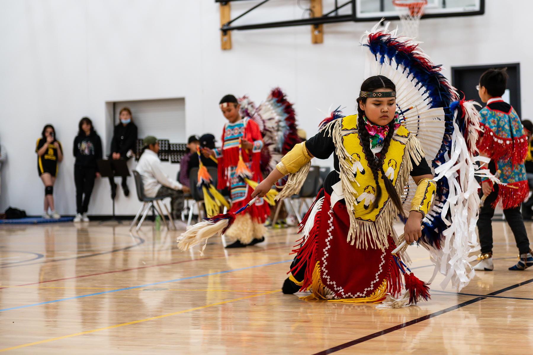 Young Indigenous girl in colourful regalia dancing