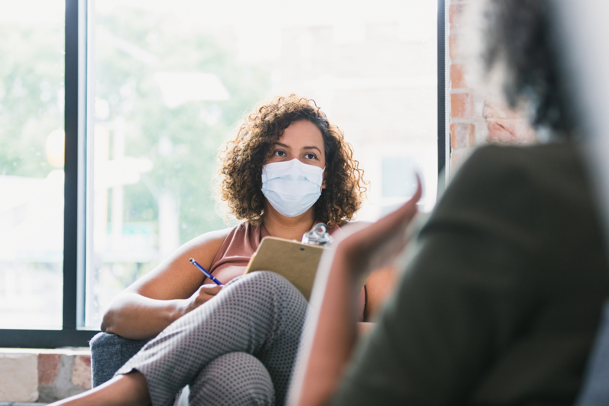 stock photo of counseling with protective masks on