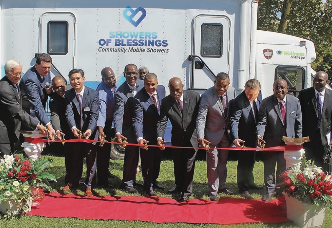 Lloyd Scharffenberg, GNYC Corporation secretary; Luis Biazotto, GNYC Adventist Community Services director; Manuel Rosario, GNYC Personal Ministries/Sabbath School director; Sung Kwon, NAD Adventist Community Services executive director; Walter Harris, GNYC ACS Disaster Response coordinator; Alanzo Smith, GNYC executive secretary; Henry Beras, GNYC president; G. Earl Knight, Atlantic Union Conference president; Ysaias Javier, GNYC treasurer; Artur Stele, General Conference vice president; and Rohann Wellington, GNYC English Ministries director; were on hand to cut the ribbon for the van’s dedication at United Camp Meeting in Wingdale, New York, on Sept. 15.