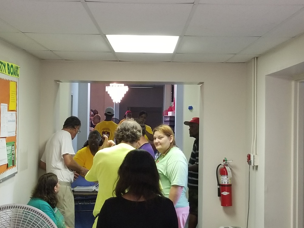 People from the neighborhood started arriving at the front desk and were accompanied by ACS DR team members as they were given food supplies and household items.