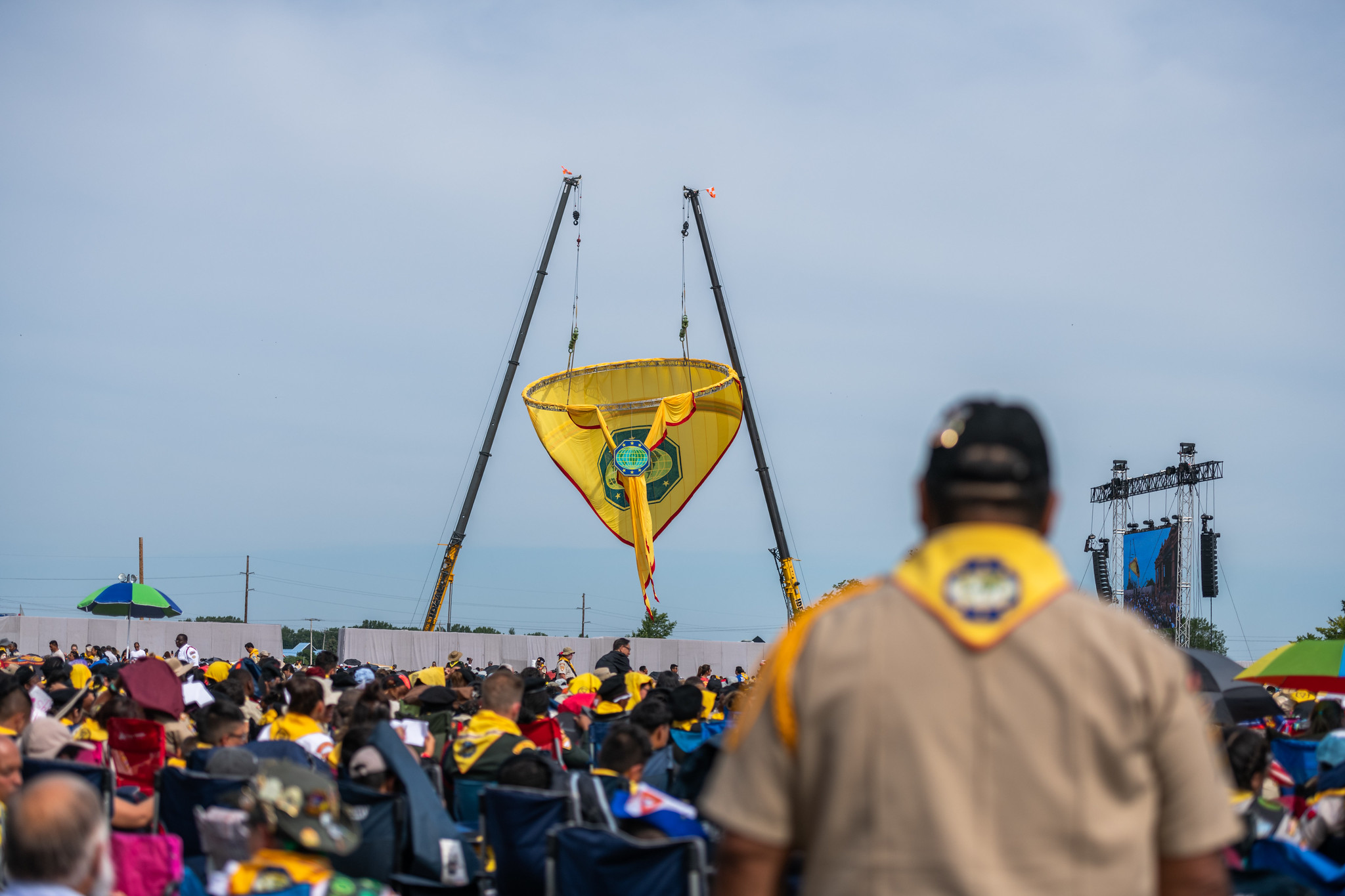 A Pathfinder leader pauses to watch the Guinness World Record Pathfinder Scarf being raised high in the Oshkosh, WI sky at The Chosen International Pathfinder Camporee 2019.