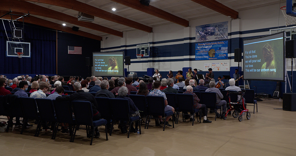 The Paradise Adventist church congregation worships in the academy gym in February 2022.