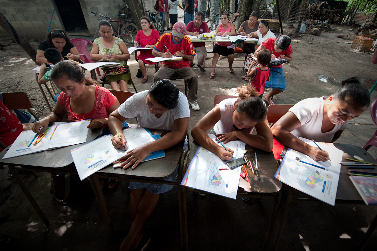 In El Salvador, adults learn to read through the Partners in Mission literacy program while their children stay close to them during study time. Photo provided by Partners in Mission