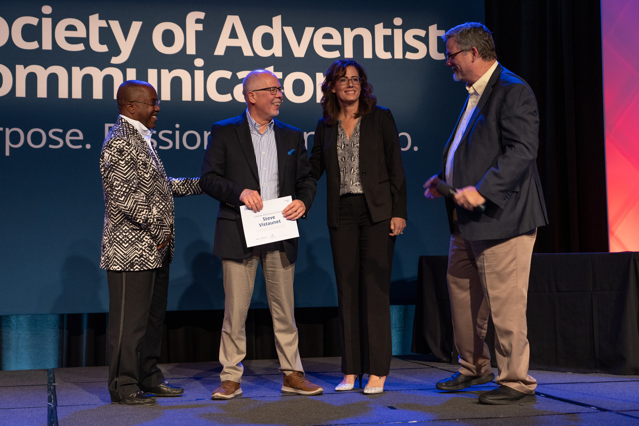 Steve Vistaunet, retiring NPUC Gleaner editor and assistant to the president of the North Pacific Union Conference, receives the SAC Lifetime Achievement Award on Oct. 19, 2019, from Bryant Taylor, SAC general vice president, Libna Stevens, SAC president, and Dan Weber, NAD Communication director and SAC executive director. Photo Pieter Damsteegt