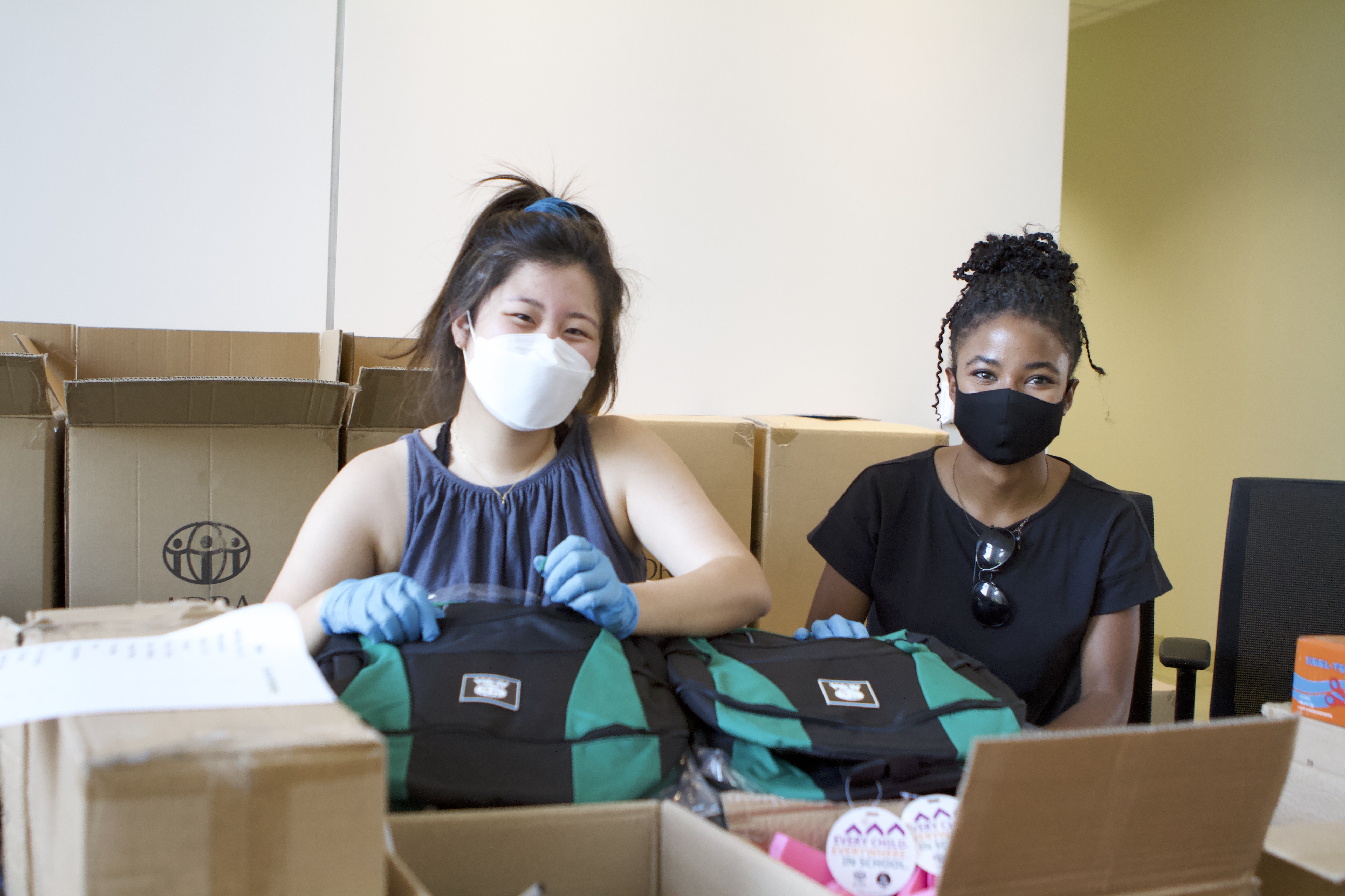 La Sierra University students Ashley Peak, left and Jodi Wilson pause for a photo while filling backpacks with school supplies. (Photos: courtesy La Sierra University)
