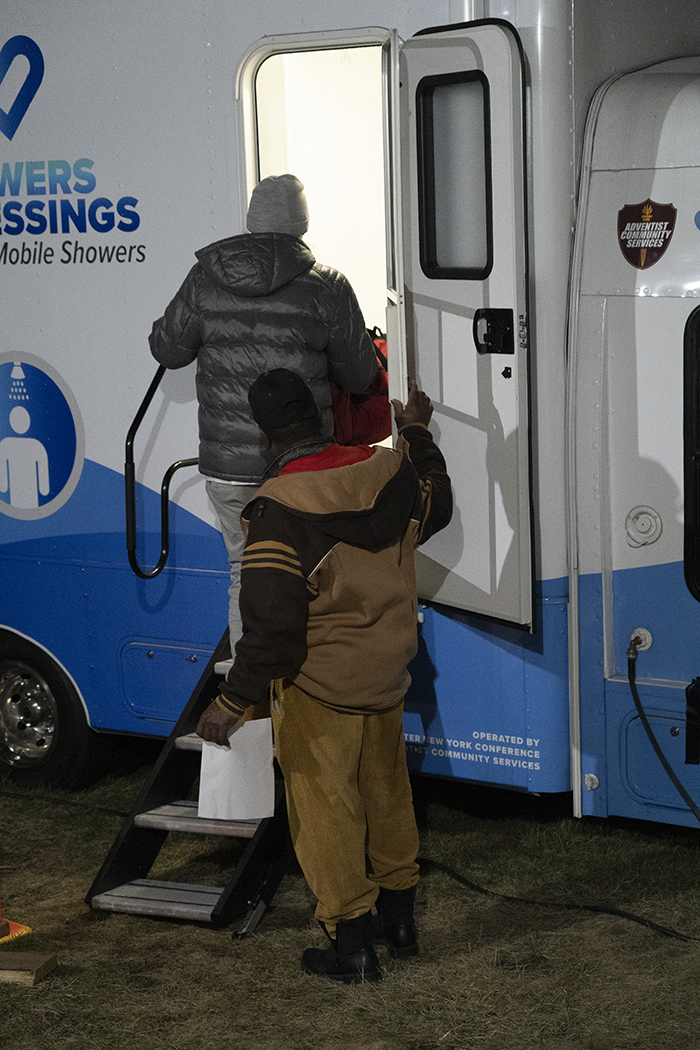 A client of the Omega Seventh-day Adventist Church’s warming center enters the “Showers of Blessing” mobile shower van that’s provided by Adventist Community Services Greater New York Conference.