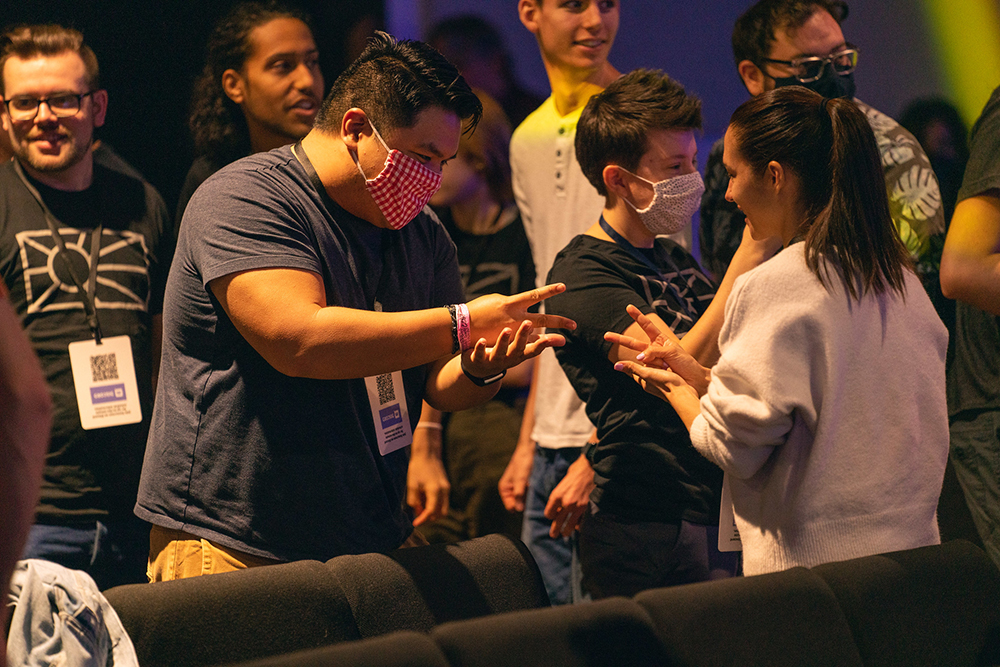 Ivana Consolani (right), lead actress of the Encounters series plays rock paper scissors in a mixer game with Raphael Jimenez, a graduate from Pacific Union College.