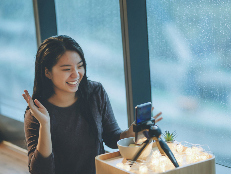 stock photo of Asian teen on phone