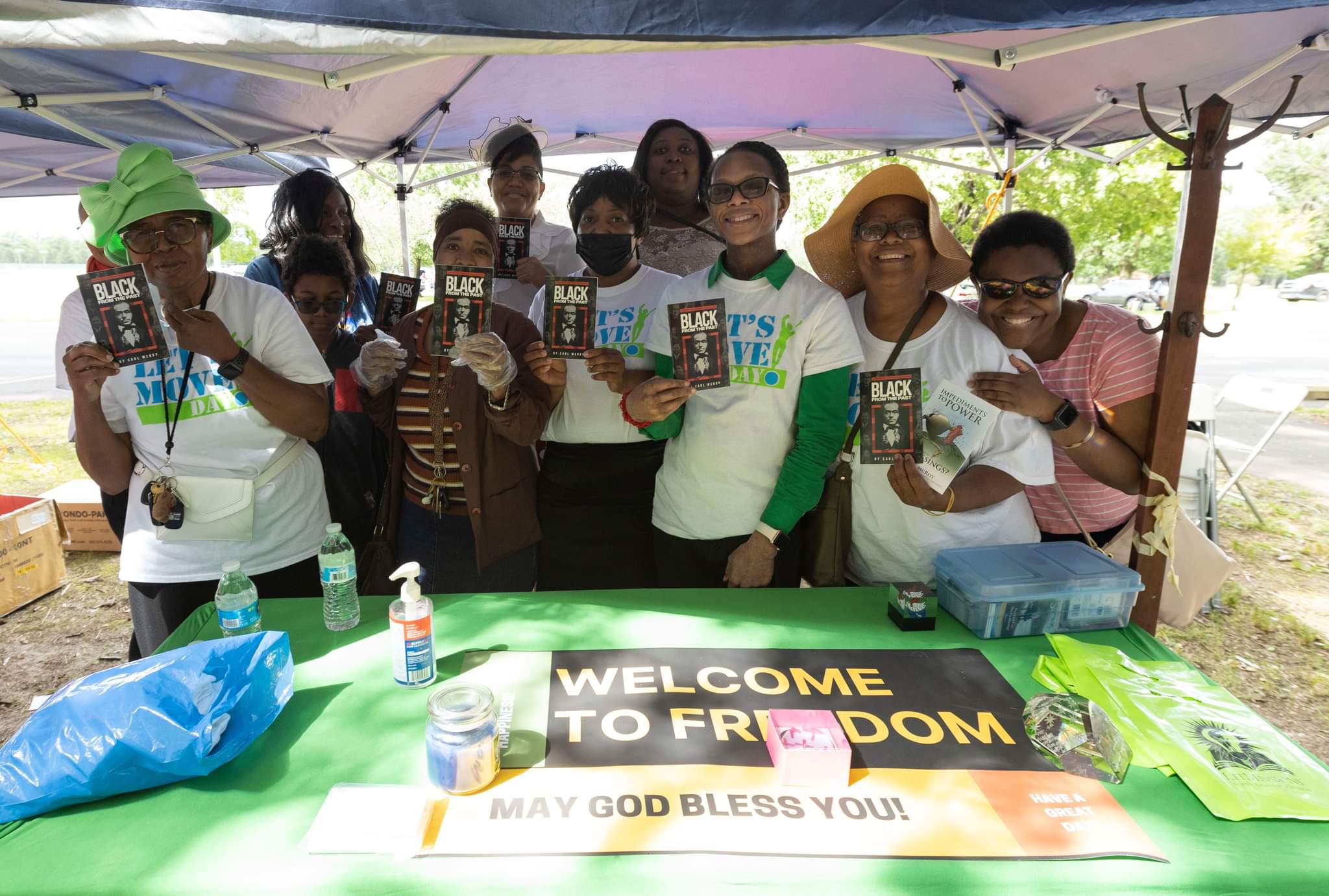 Willingboro church members pose with one of the books handed out at the Juneteenth festival
