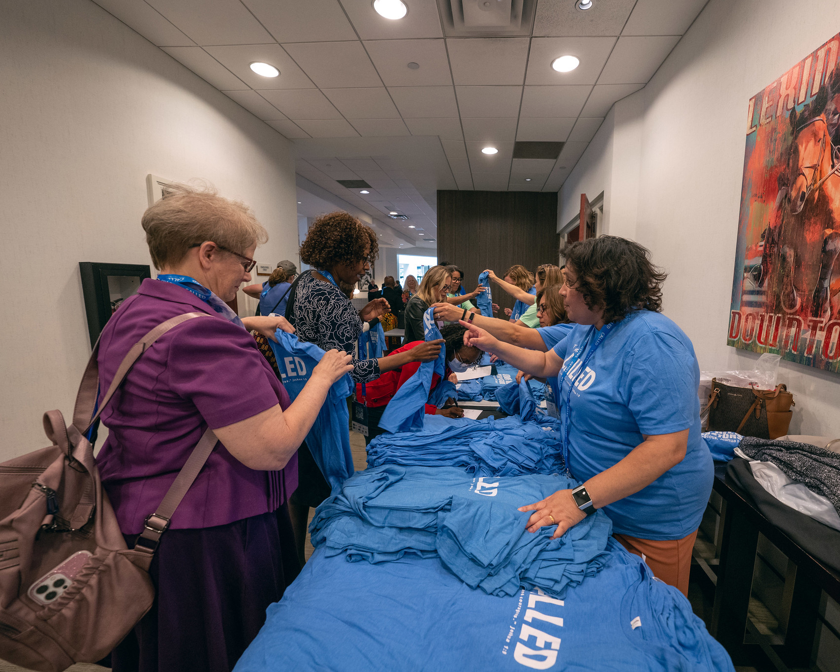 Caption for shirt photo: Pastors pick up their “I am called” T-shirts at the exit.