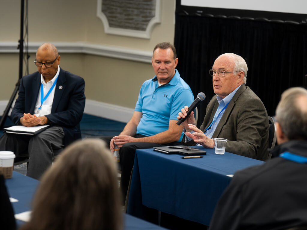 Three men in a panel discussion