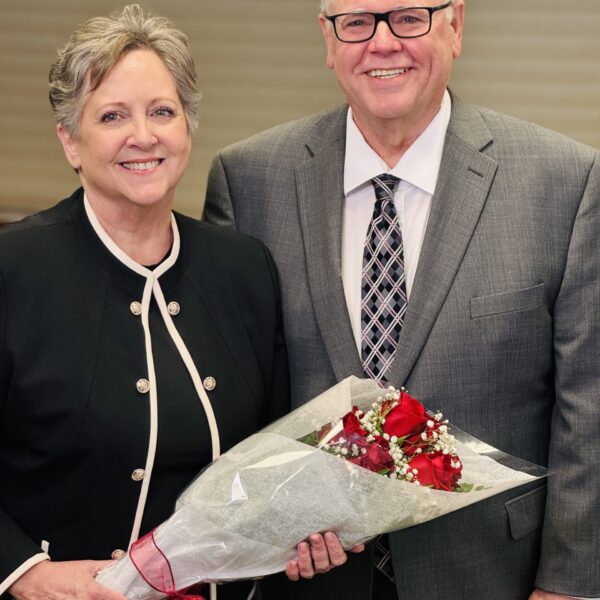 Caucasian, middle/late age male and female posing with bouquet of flowers