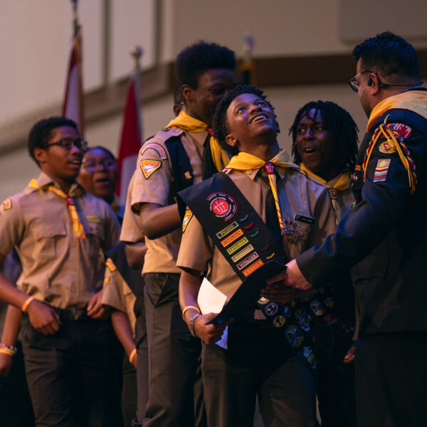 A Pathfinder team collects their certificates from Pathfinder Bible Experience organizer Armando Miranda on stage.